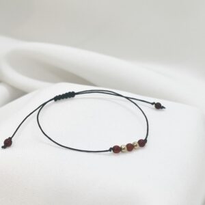 Bransoletka z bursztynowych kuleczek ze złotem 585 na czarnym sznurku